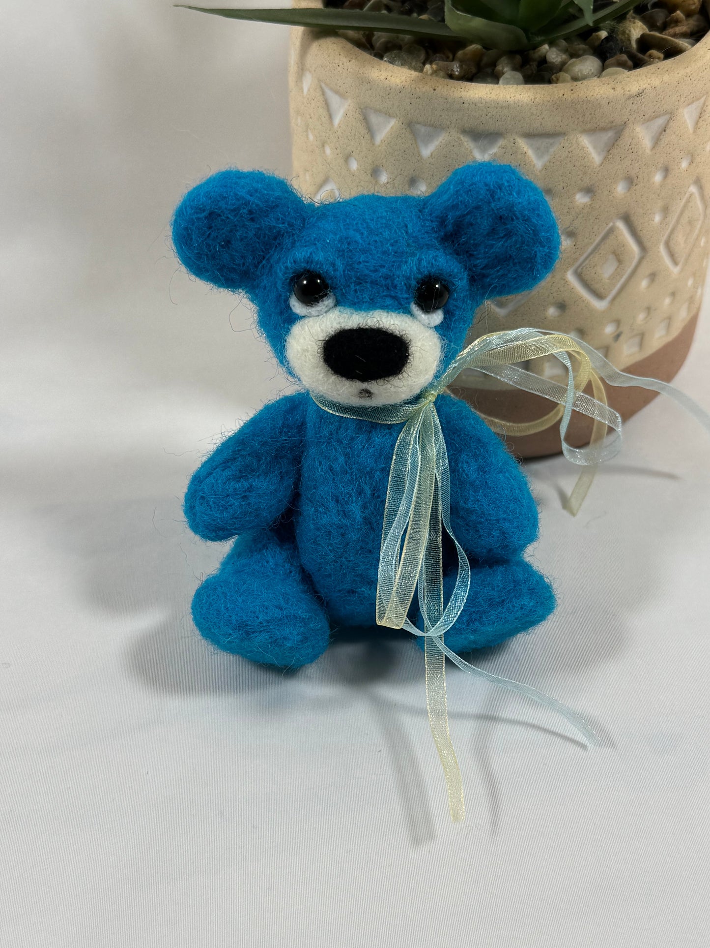 Gros plan de l’ours Blue articulé, ours en laine bleue feutrée fait mai