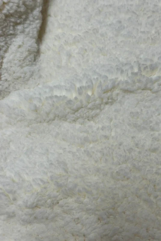 Soft and thick faux fur fabric coupon with cream white curly medium-length hair 39cm x 160cm