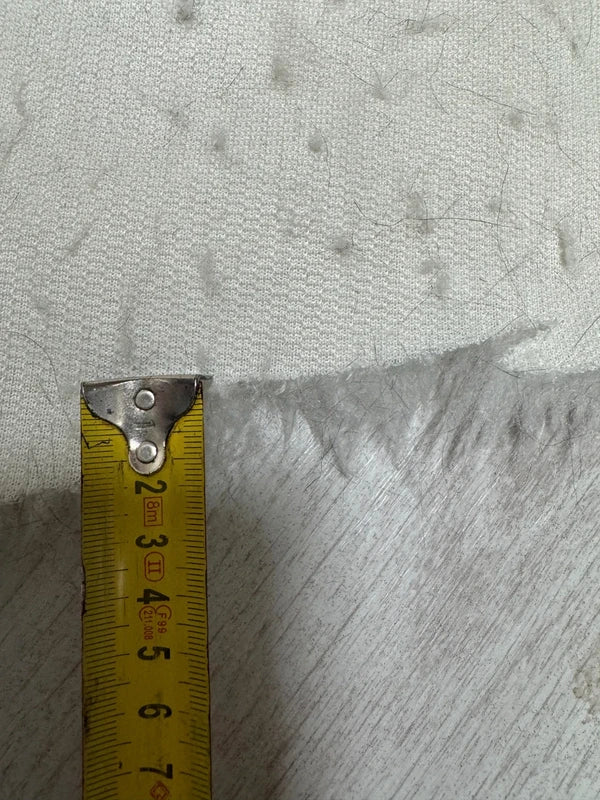 Coupon tissu fausse fourrure douce à poils mi-longs frisés blanc 30cm x 70cm