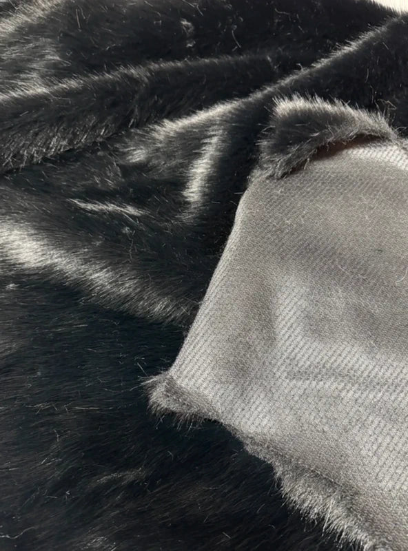 Coupon tissu fausse fourrure douce de qualité noir à poils mi-longs 34cmx93cm